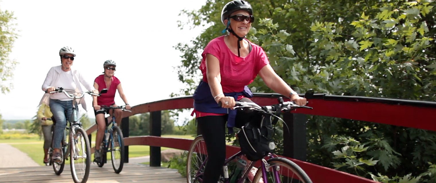 Group of women cycling over a bridge